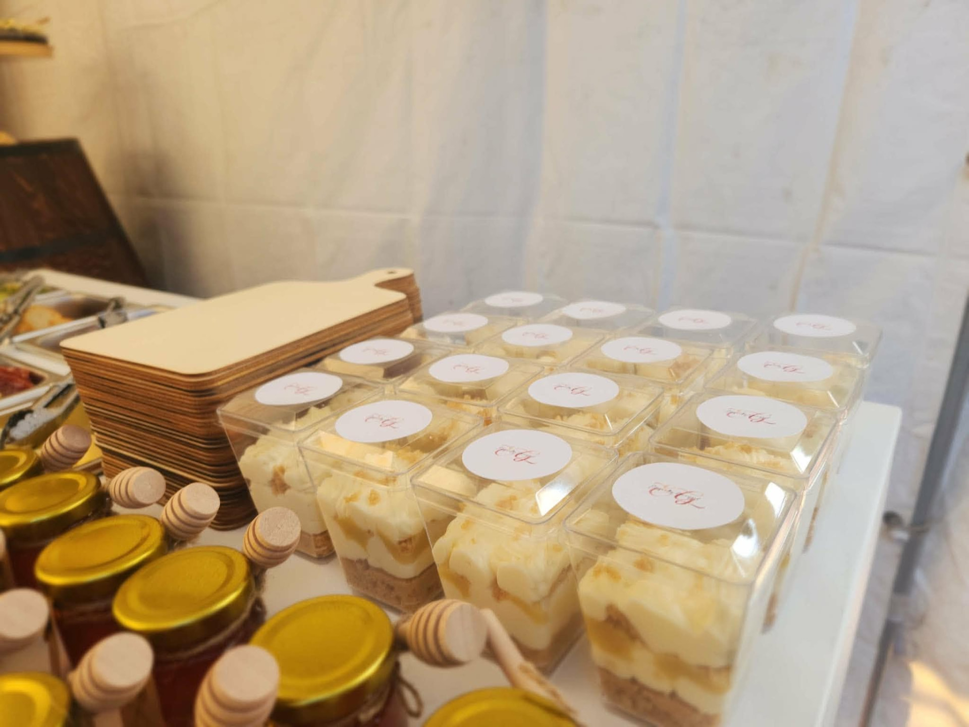 Dessert cups alongside honey jars